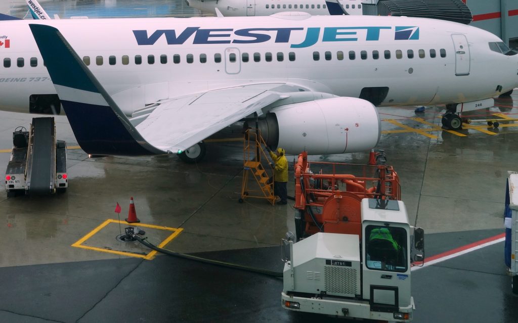 Westjet Boeing 737-700 being refueled from a ramp hydrant through a pump truck at YYZ