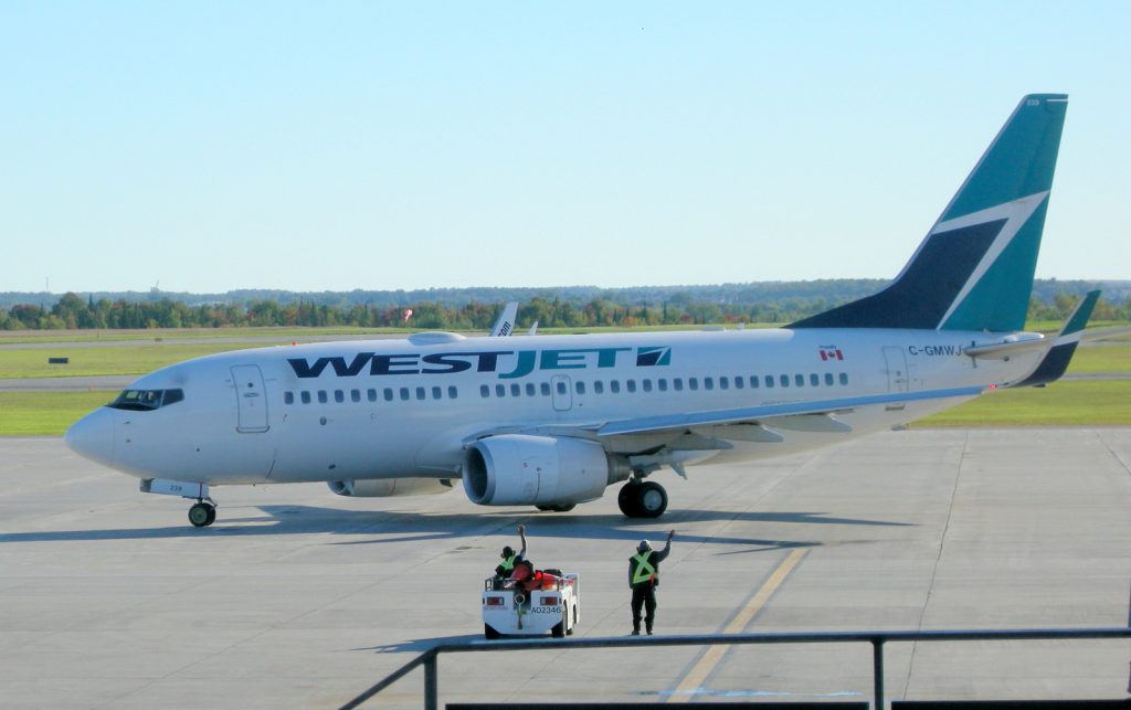 Westjet "rampies" wave goodbye after a quick turnaround at Ottawa YOW