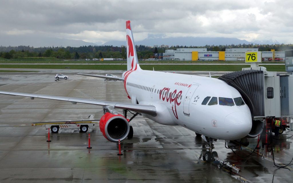 Air Canada rouge's inaugural YVR-LAS Airbus A319 flight at the gate on a rainy Vancouver morning